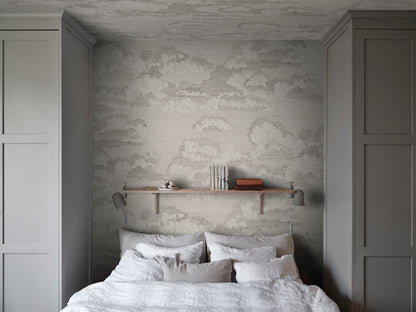 Experience the quiet elegance of the Bonnie wallpaper in graphite. This design captures a dreamy sky view with scattered clouds that evoke classic etchings