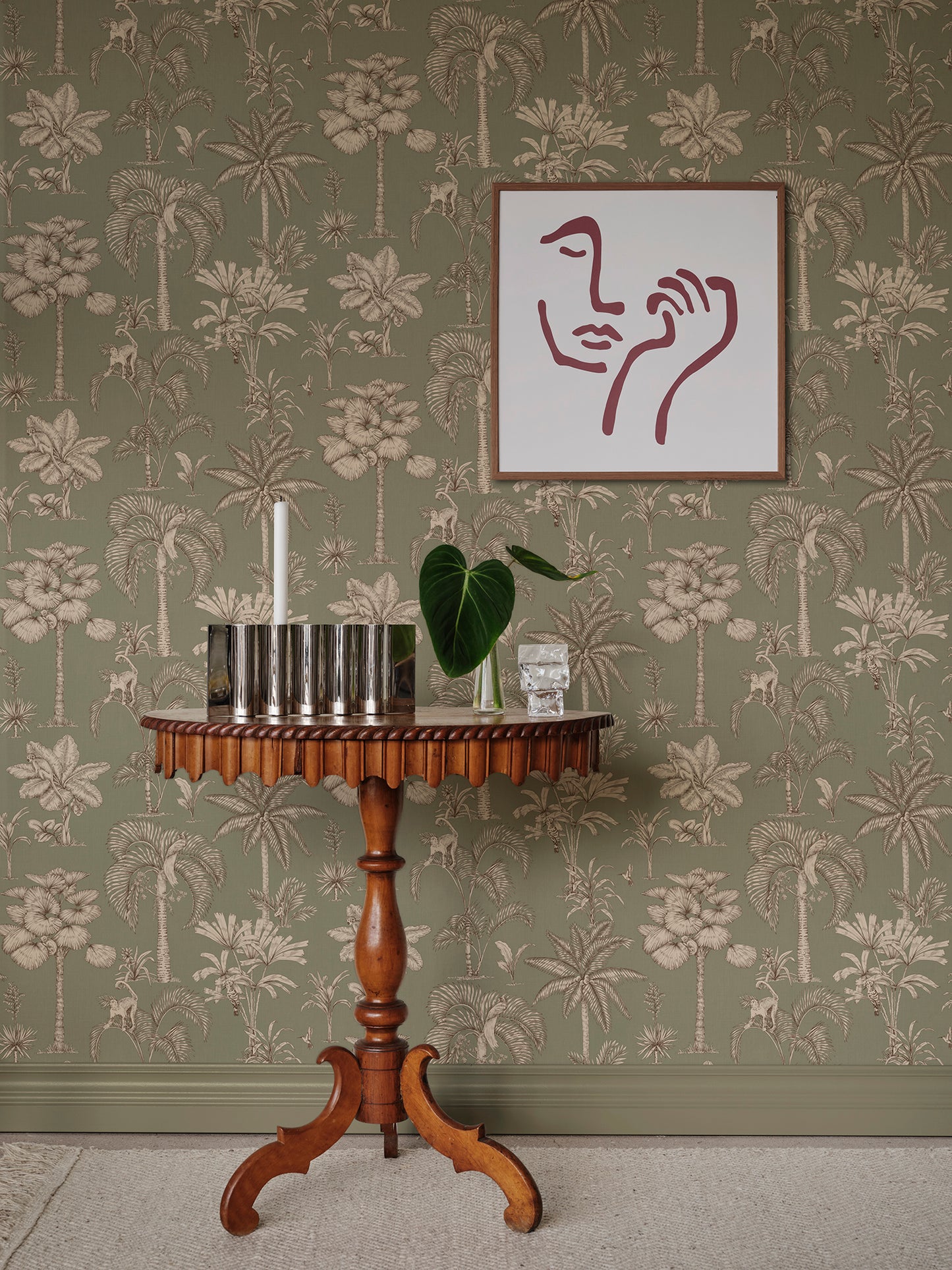  This intricate wallpaper design, set against a calming green backdrop, enchants both young and old with its toile-like elegance and hidden wonders from nature. 