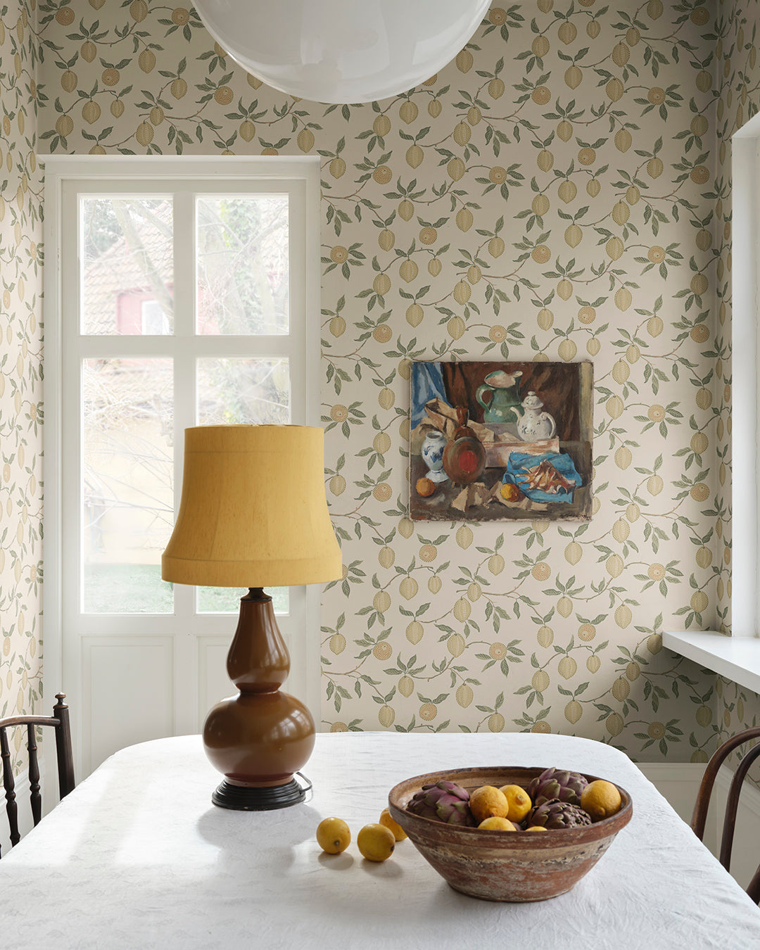 Let the captivating Limone wallpaper whisk you away to sun-drenched Italian groves. With its vibrant lemon branches and lush green leaves, this design refreshingly encapsulates the zest of life. Perfect for adding a splash of color and a touch of Mediterranean flair to your space.