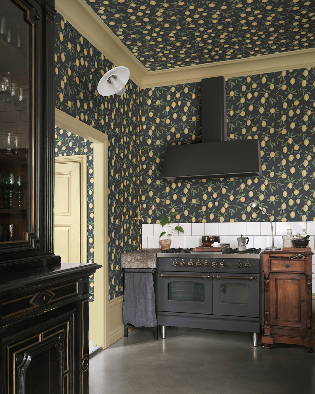 Embrace the essence of Mediterranean lemon groves with Limone in Charcoal. The vibrant lemon branches against a deep charcoal backdrop bring a fresh yet sophisticated touch to any space. This pattern is perfect for adding a slice of sunshine and a pop of color to your interiors.