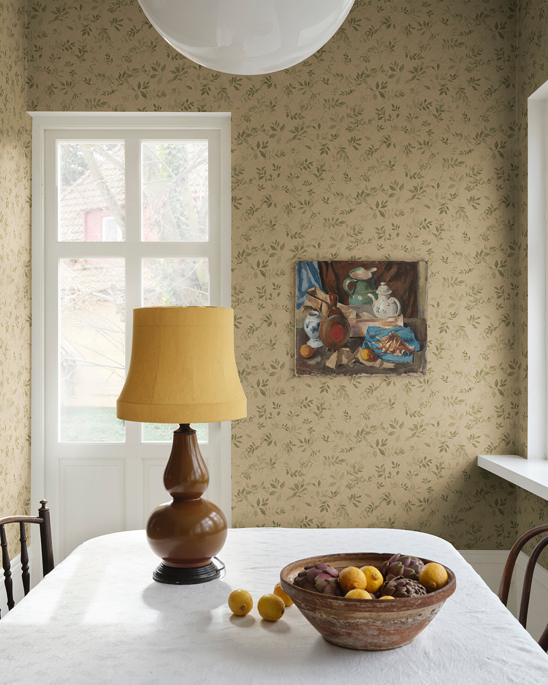 Invoke a romantic aura with the Mila wallpaper. Inspired by antique frescoes, its olive green leafy vines exude depth and patina, creating a timeless elegance in any space. The pattern’s charm lies in its ability to bring walls to life, embodying a beautifully aged look that melds seamlessly with your decor.