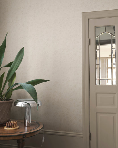 Infuse your space with the elegance of the Mila Beige wallpaper. This pattern, inspired by antique al fresco paintings, features romantic leafy vines with a warm patina. The subtle depth and aged aesthetic seamlessly blend into any room, bringing a touch of timeless sophistication.