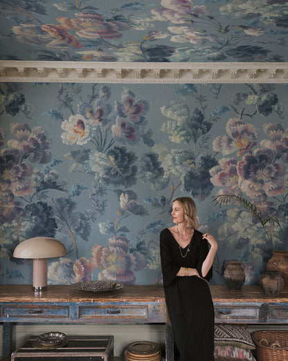 Immerse your space in a stunning floral cavalcade with Ines, where soft painterly blooms meander across a serene blue backdrop. This 19th-century inspired design creates a seamless blend of history and elegance, making every room a visual delight.