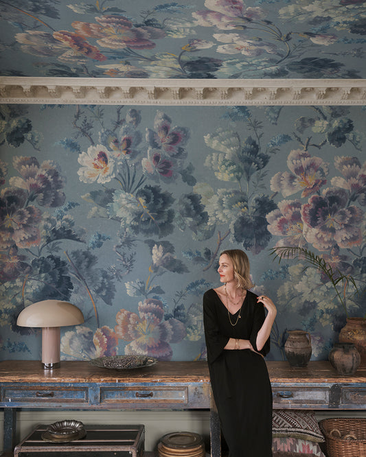 Immerse your space in a stunning floral cavalcade with Ines, where soft painterly blooms meander across a serene blue backdrop. This 19th-century inspired design creates a seamless blend of history and elegance, making every room a visual delight.