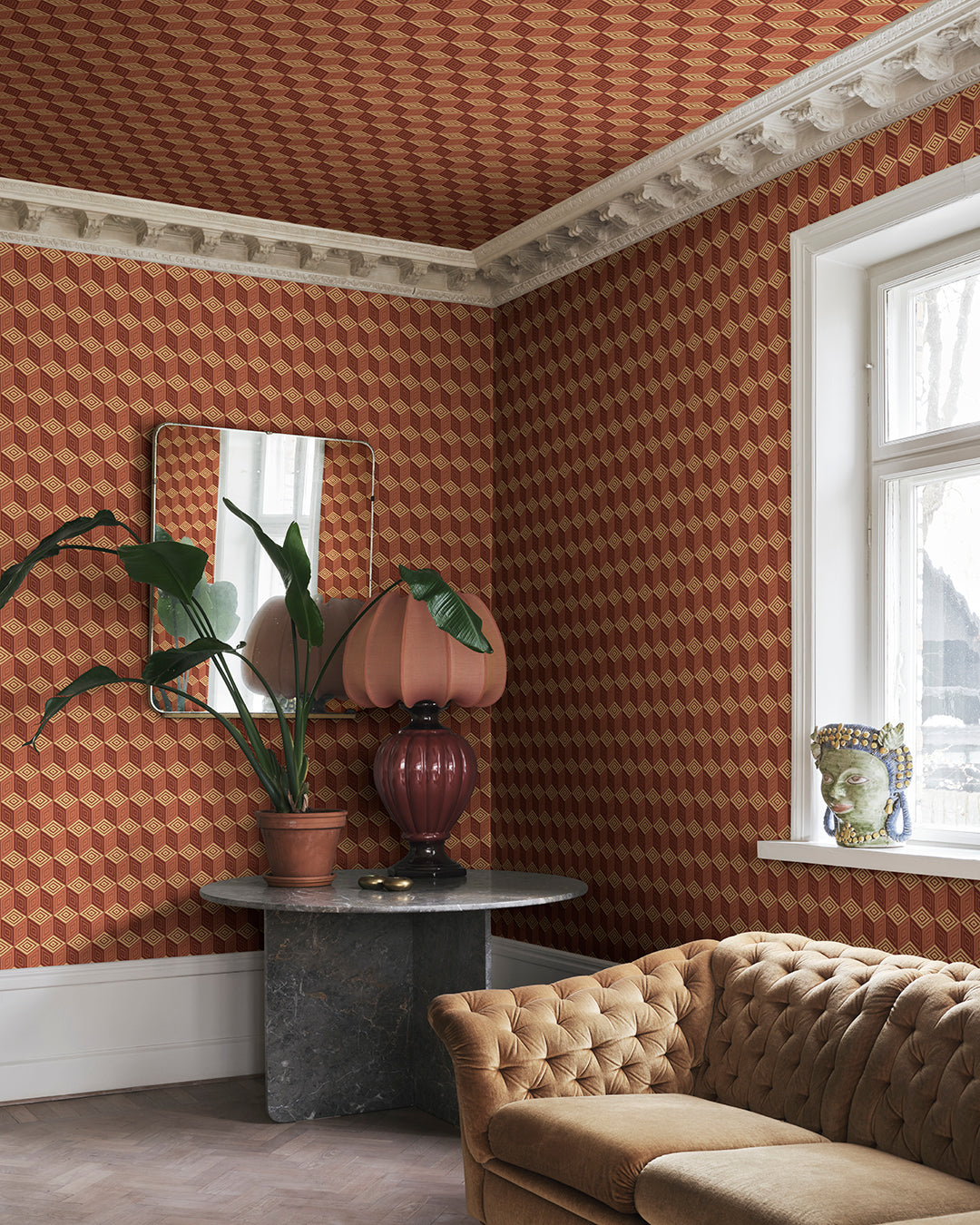 Chiara in terracotta captures the elegance of Como's renowned silk heritage with a striking geometric pattern. This design mimics an elegant scarf, infusing a touch of modern international flair and decorative warmth into any space. The vivid palette of rich terracotta hues brings an inviting vibrancy to your walls.