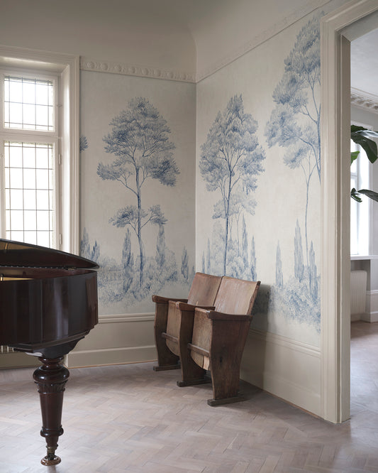 Enhance your space with the Andrea mural's classical charm. Featuring hand-drawn Italian gardens in serene blue, this piece infuses any room with historical and natural beauty. Tall conifers stand majestically, creating a sense of depth and timeless elegance that transforms your walls into a picturesque landscape.
Designed by Karolina Kroon
