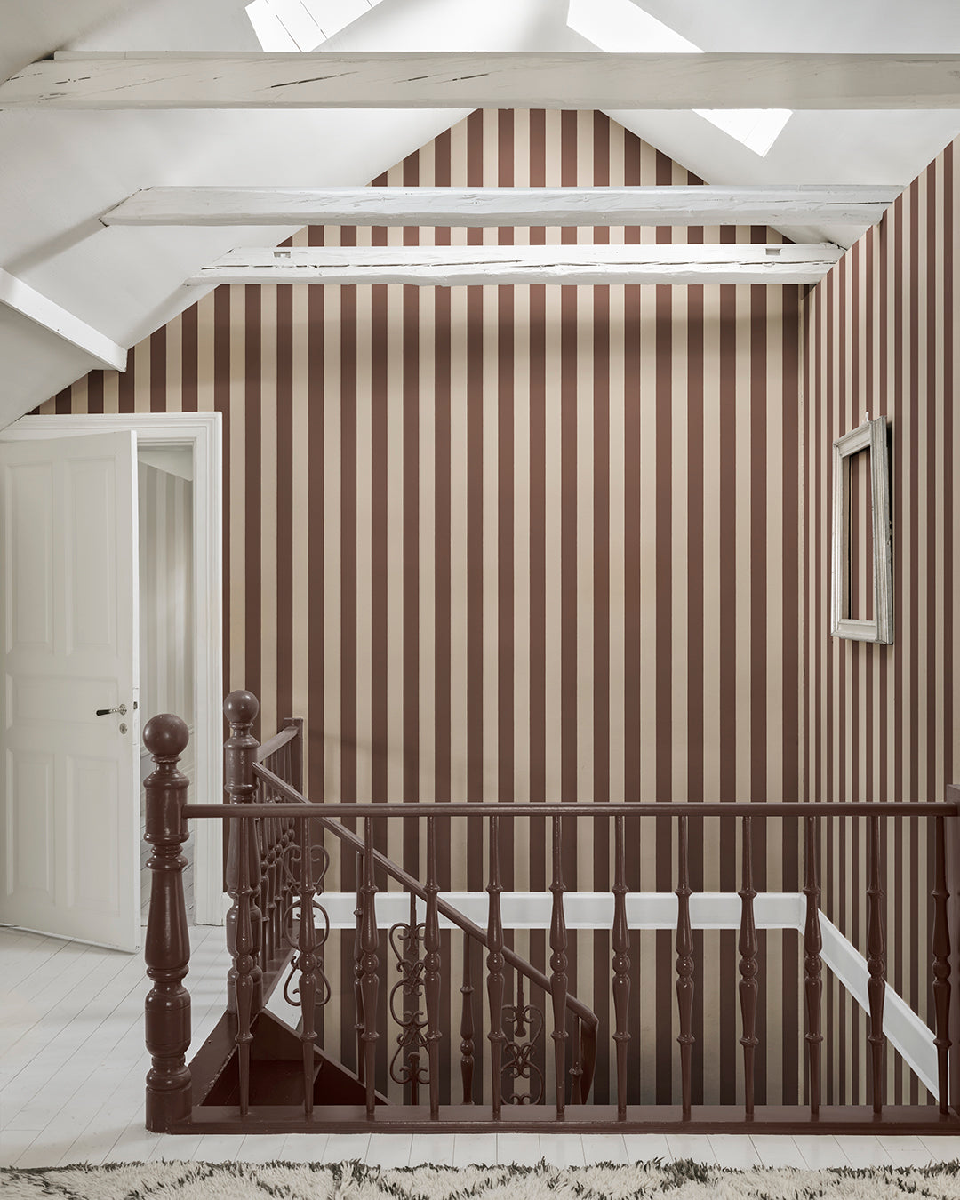 Sam in Burgundy is a sophisticated stripe pattern, blending Southern European elegance with rich, warm colors. Ideal for creating visual height and adding a touch of timeless charm to any space. This wallpaper can be used alone or paired with other designs for a coordinated look.