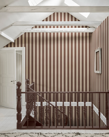 Sam in Burgundy is a sophisticated stripe pattern, blending Southern European elegance with rich, warm colors. Ideal for creating visual height and adding a touch of timeless charm to any space. This wallpaper can be used alone or paired with other designs for a coordinated look.