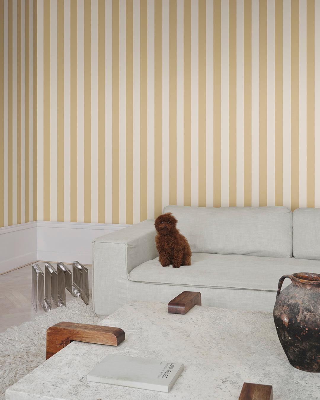 The Sam, Honey wallpaper features timeless stripes in warm hues, adding a touch of Southern European elegance to any room. Ideal for those seeking a blend of classic and contemporary style in their space.