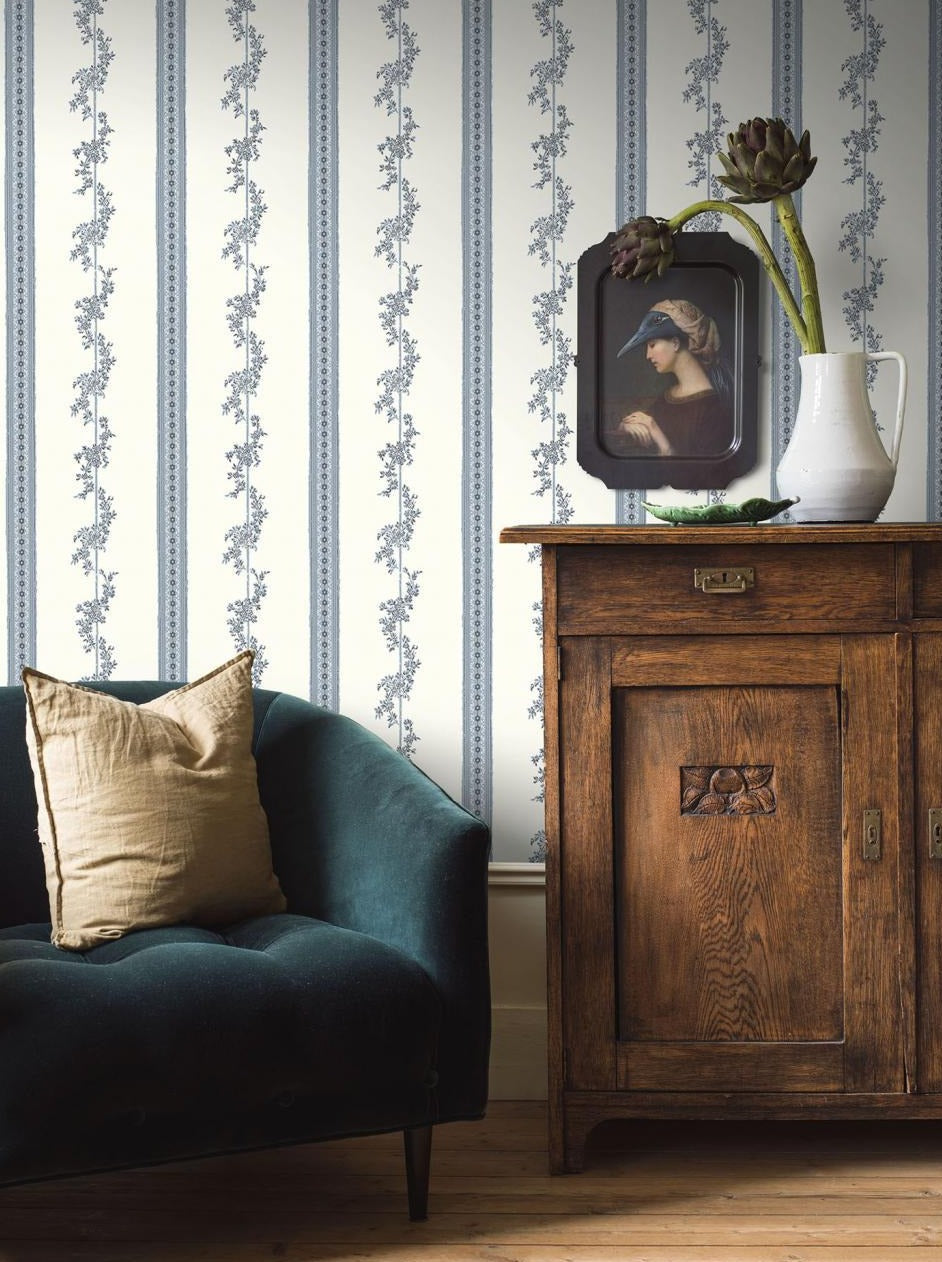 Decorated in delicate frosted blues and soft creams, this beautiful and intricate design of looping floral totems and banded daisies is inspired by remnants of wallpaper found hanging in the old Drottningholm Palace Theatre. 