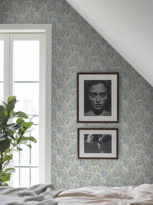 Colored in playful hues of green, gold, blue and purple across a soft blue-grey backdrop, our Flora wallpaper is light, bright and optimistic.
