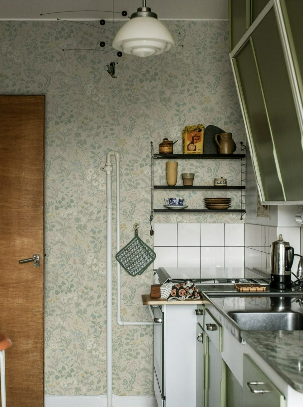 Colored in a pretty pastel palette of green, pink, yellow, white and blue, our Flora wallpaper celebrates the sublime sights and scents of a Swedish spring meadow.