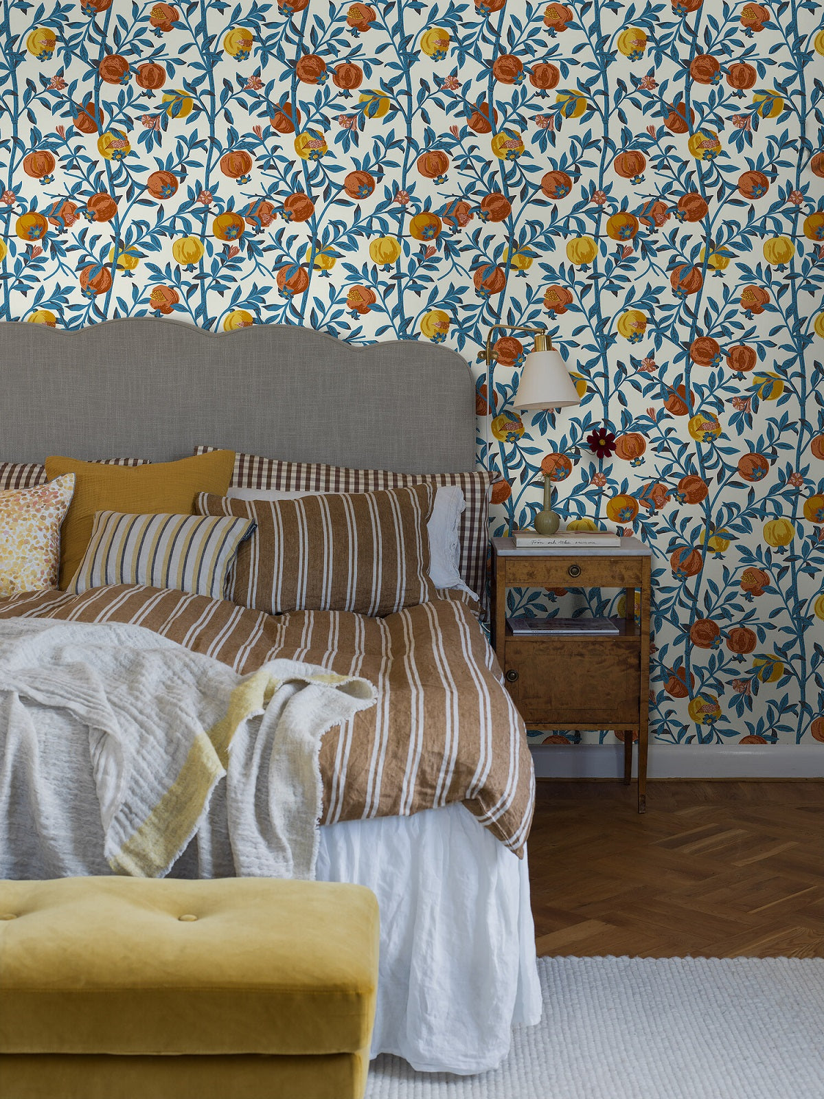 Colored in shades of vibrant blues, yellows and oranges on a white background, our Granatäpple wallpaper, uses an overprint technique allowing new shades to emerge in the mix of two prints. 
