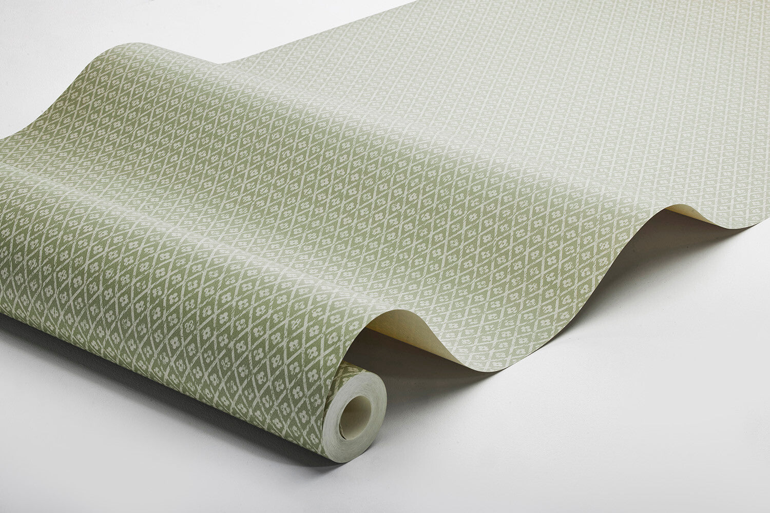 Willowherb wallpaper is simple and rustic. Having the appearance of a single-color surface from a distance, its pretty petite design features a stylized four-petal flower within a diamond trellis pattern.